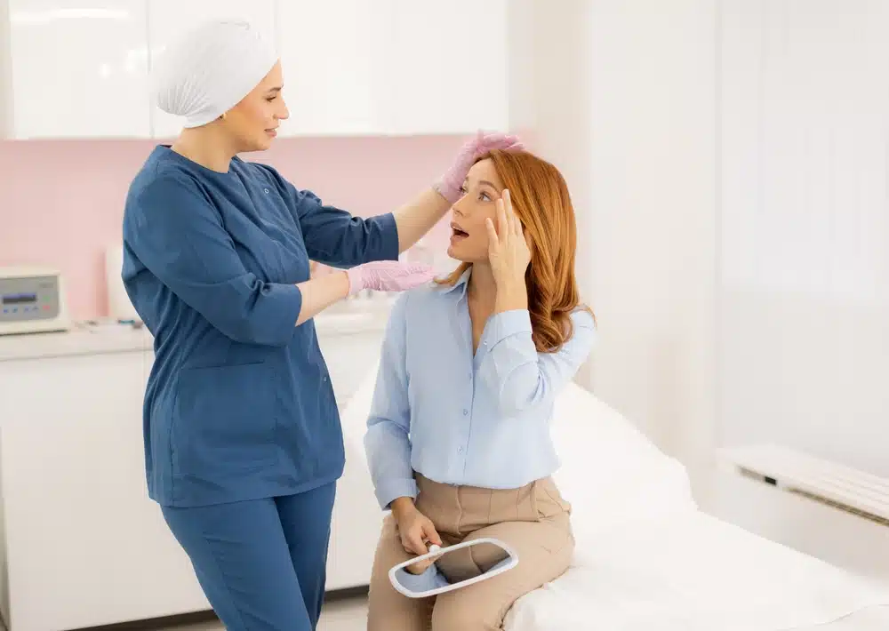 A dermal therapist doing a skin consultation with a client