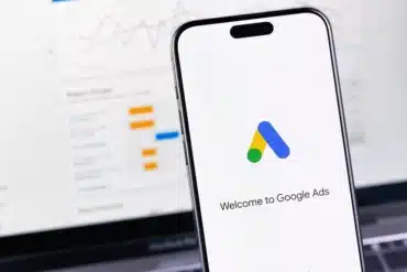 Google Ads logo app on a smartphone iPhone, and MacBook.