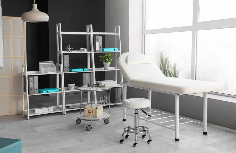 Interior of modern medical office with couch and shelf unit